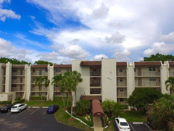 Front view of a multi-story apartment building with balconies.