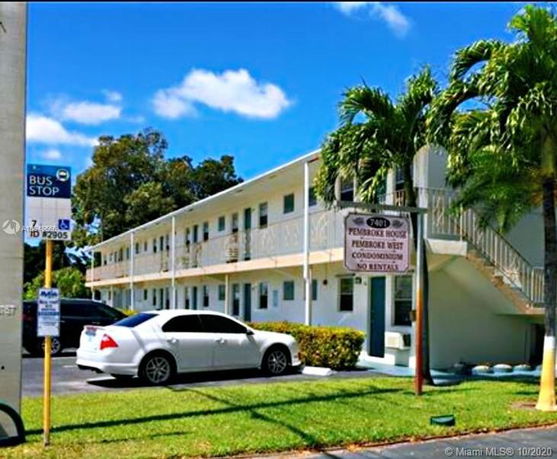Front view of a two-story condominium building with outdoor stairs.
