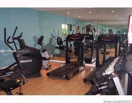 Gym area with exercise equipment including treadmills and weights