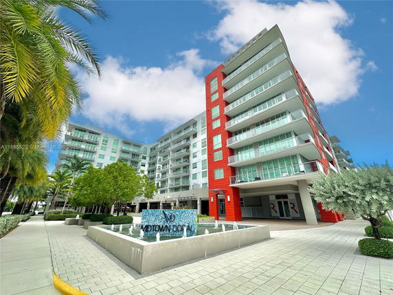 Front view of a modern multi-story building with balconies.