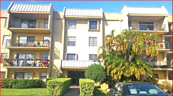Front view of a multi-story apartment building with balconies.