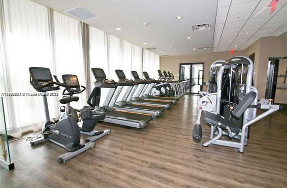 Interior view of a gym with treadmills and exercise machines.