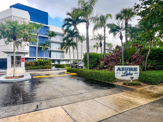 Front view of a multi-story building with a blue and white exterior.