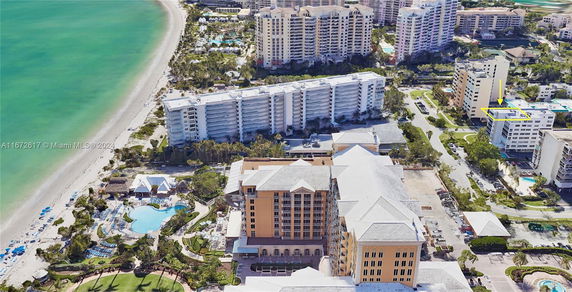 Aerial view of beachfront buildings and coastline.