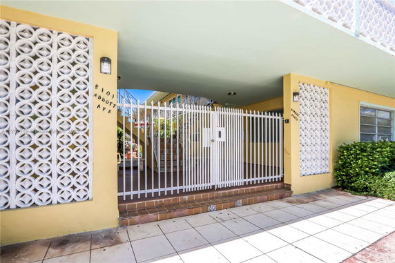 Front view of a building with a gated entrance and decorative wall panels.