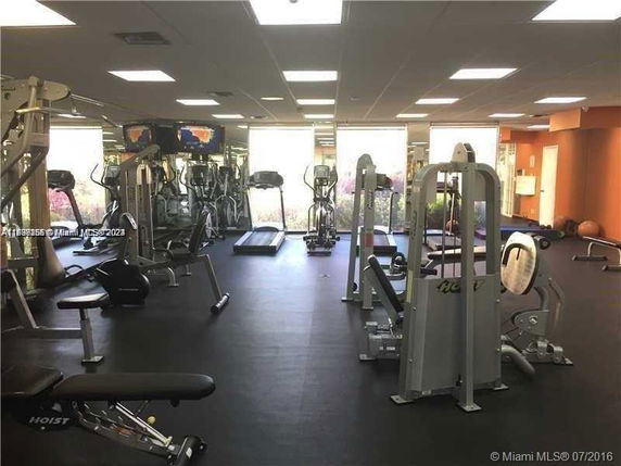 Indoor gym area with various exercise equipment.