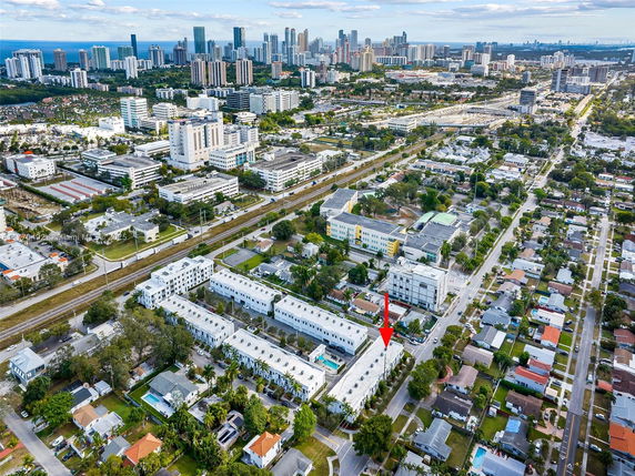 Aerial panoramic view of an urban area with residential and commercial buildings.