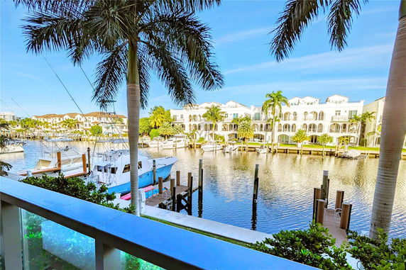 View of waterfront luxury buildings with boats at a marina.