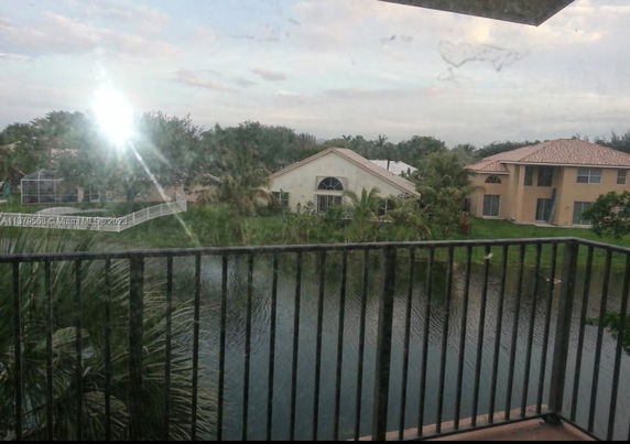 View of residential houses and a water body from a balcony.