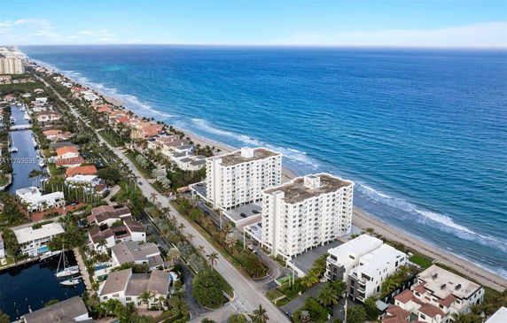 Aerial view of beachfront apartment buildings and residential area along coastline.