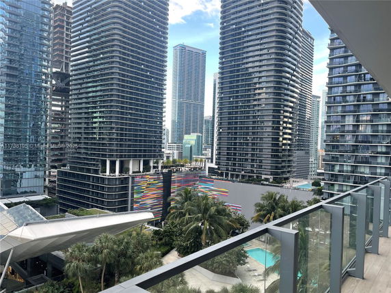 View of high-rise buildings from a balcony in an urban area.