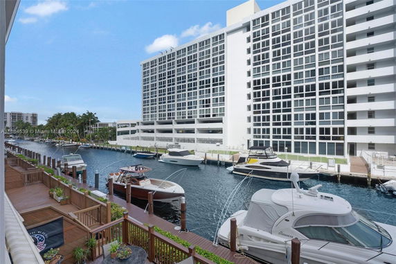 View of a waterfront residential building with docked boats.