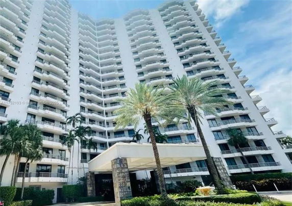 Front view of a multi-story residential building with balconies.