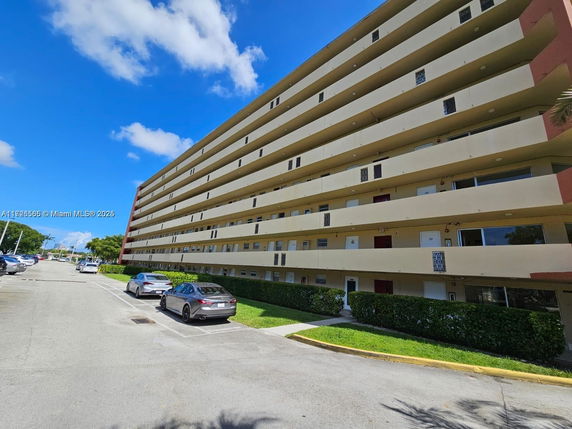Front view of a multi-story residential building with balconies.