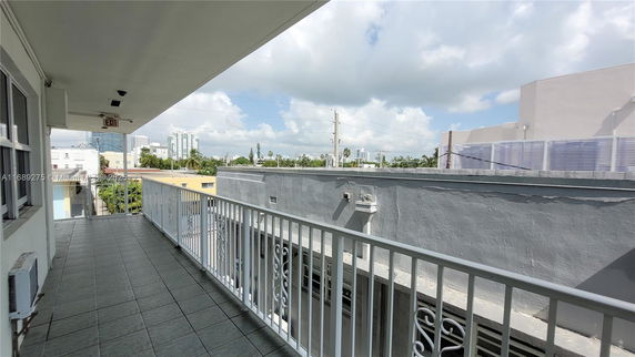 View from the rooftop showing railings and surrounding buildings.