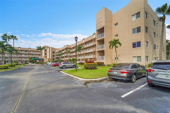 Front view of a multi-story apartment building with balconies.