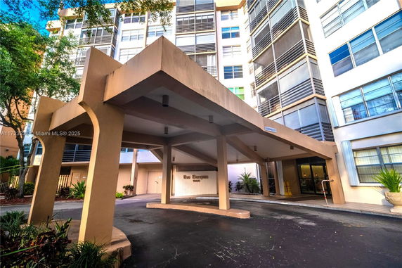 Front view of a multi-story building with a covered entrance.