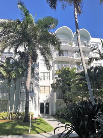 Front view of a multi-story residential building with balconies.