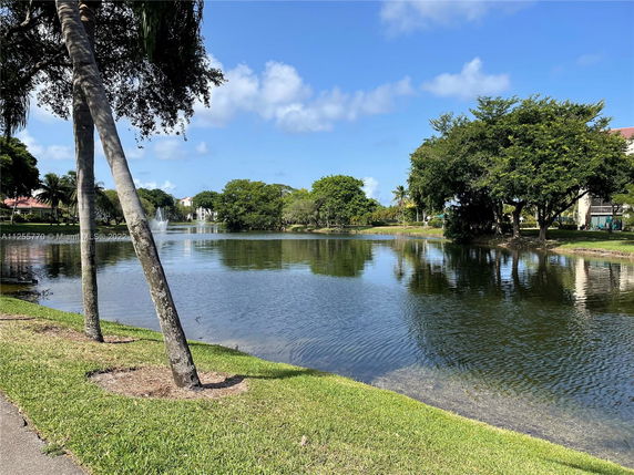 Scenic view of a lake surrounded by trees and buildings.