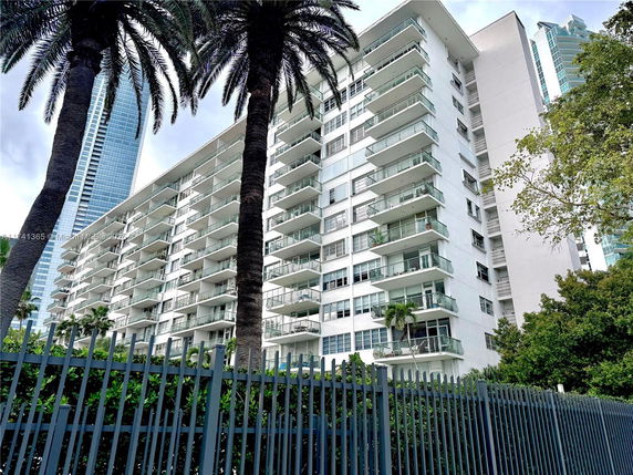 Front view of a multi-story residential building with balconies.