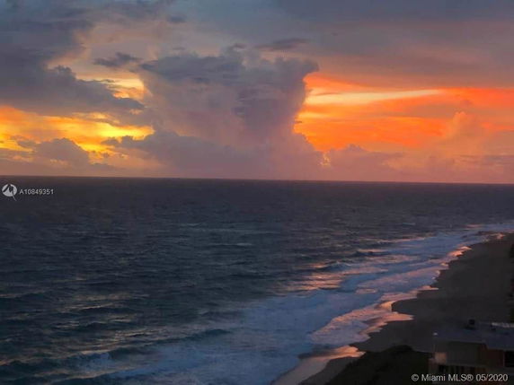 Panoramic view of the ocean and beach at sunset.
