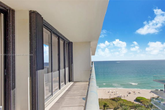 Balcony view overlooking the ocean and beach.