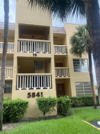 Front view of a multi-story residential building with balconies.