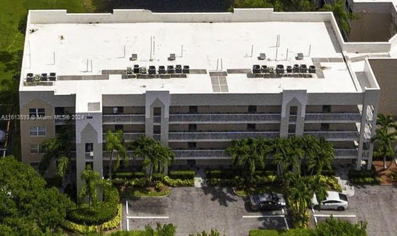 View of a multi-story building with a flat roof featuring multiple air conditioning units.