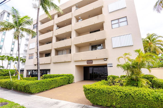 Front view of a multi-story building with balconies.