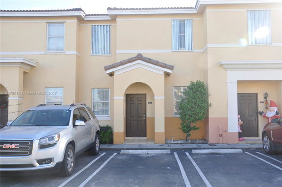 Front view of a two-story house with a small entrance porch.