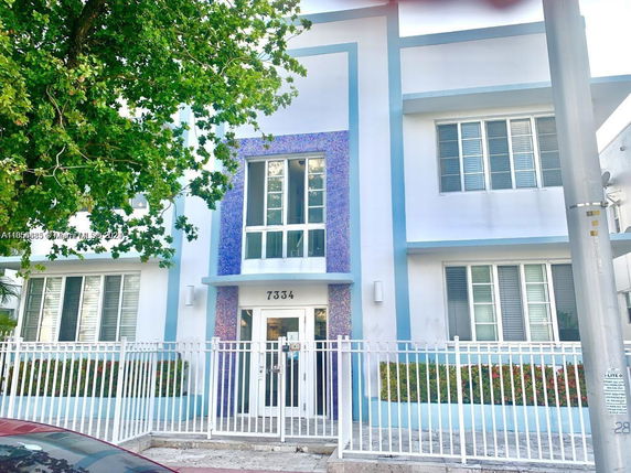 Front view of a two-story building with a modern design and gated entrance.