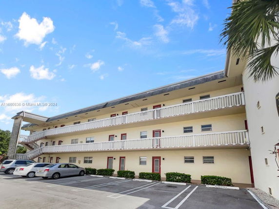 Front view of a multi-story residential building with balconies.