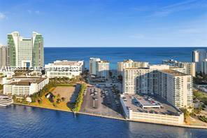 Aerial view of a coastal area with multiple high-rise buildings near the ocean.