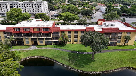 Aerial view of a multi-story apartment building with a flat rooftop.