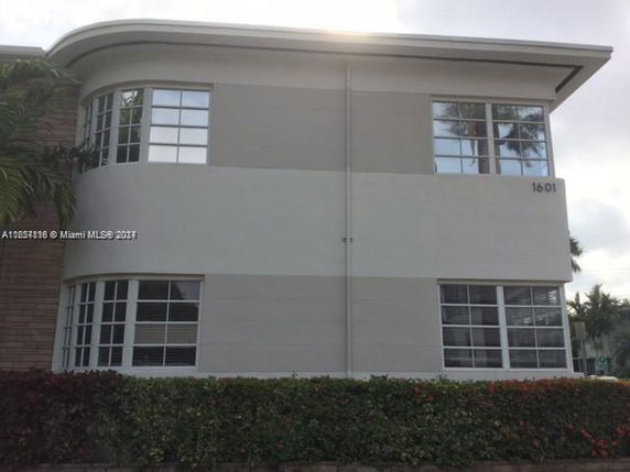 Front view of a two-story building with multiple windows.