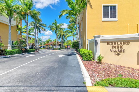 Front view of a building entrance labeled Highland Park Village.
