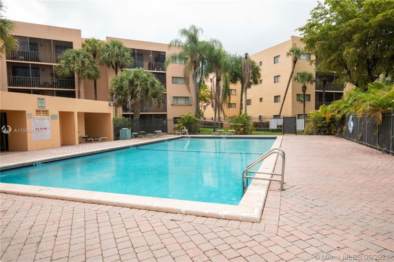 Outdoor swimming pool with surrounding apartment buildings.