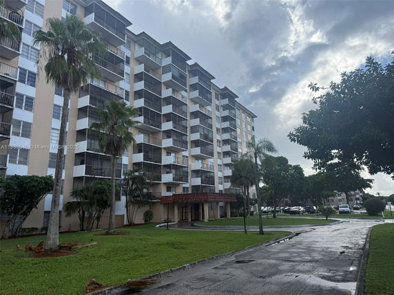Front view of a multi-story apartment building with balconies.