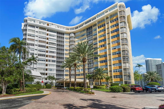 Front view of a high-rise building with multiple balconies.
