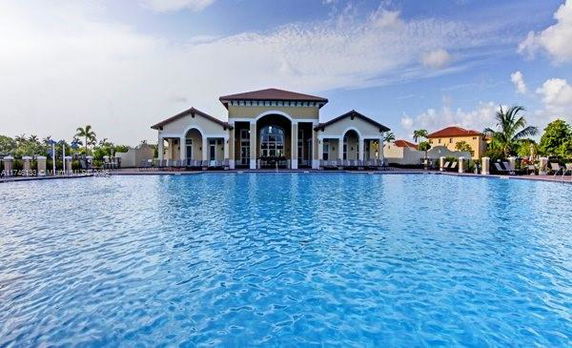 Pool view with a large building in the background.