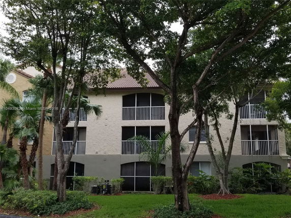 Front view of a three-story residential building with balconies.