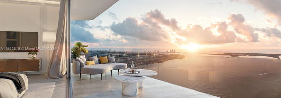 Panoramic view of a cityscape and waterfront seen from a balcony.