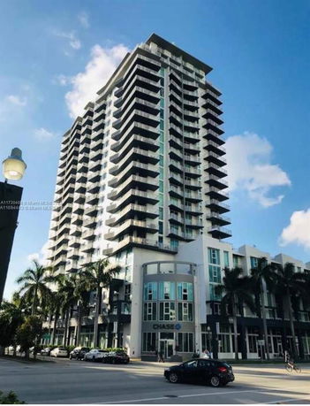 Front view of a high-rise building with multiple balconies.