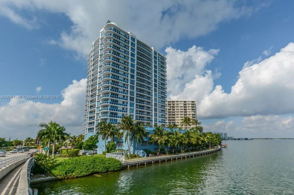 View of a high-rise condominium building by the water.