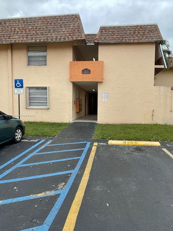 Front view of a two-story building with accessible parking space.