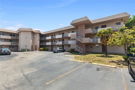 Front view of a three-story apartment building with balconies.