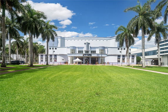 Front view of a large white building with an Art Deco design.