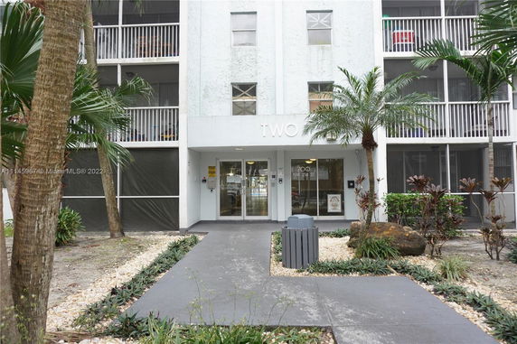 Front view of a multi-story building with balconies.