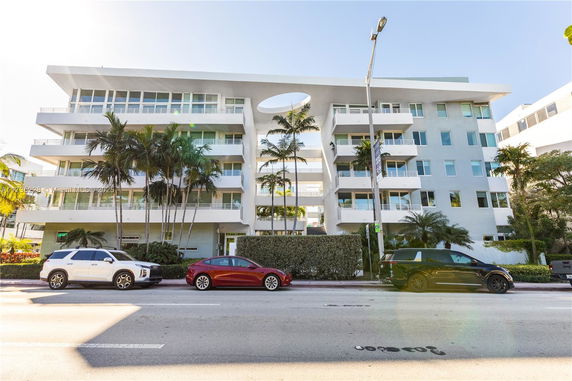 Front view of a multi-story residential building with balconies.