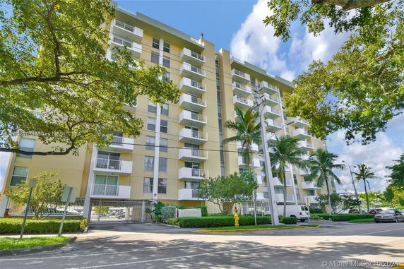 Front view of a multi-story residential building with balconies.